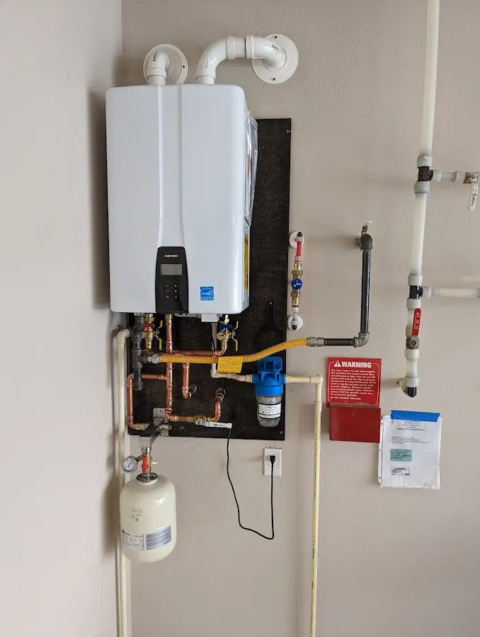 Professional plumber installing copper piping in a Netcong home